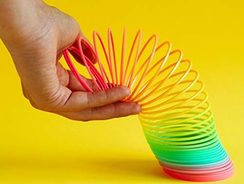 JA-RU rainbow spring toy expanded between two hands demonstrating its elastic and flexible premium plastic build.