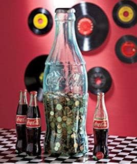Side angle view of the two foot tall transparent Coca-Cola savings container filled with various coins.