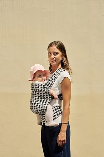 Parent wearing Grownsy carrier with baby facing inward