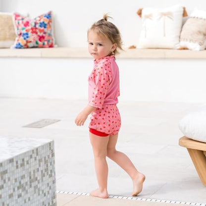 Side profile of baby wearing Splash About Happy Nappy Sunsuit