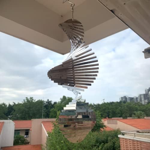 Decorative kinetic wind spinner reflecting sunlight