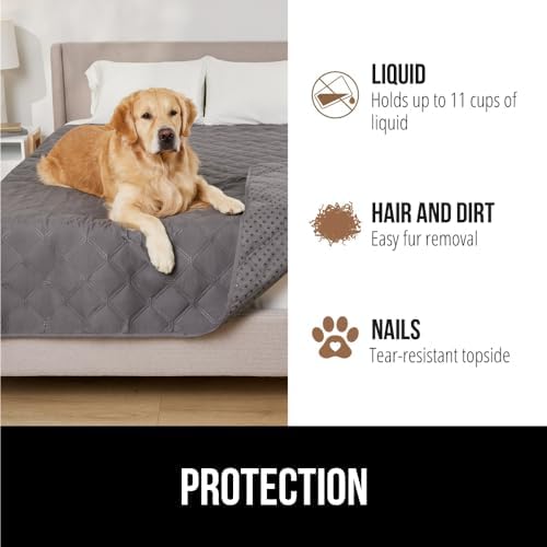 A small dog resting comfortably on the tear resistant charcoal quilted pet blanket.