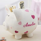 Bottom view of the Personalization Universe large pink piggy bank focusing on the removable plastic stopper plug for easy money retrieval