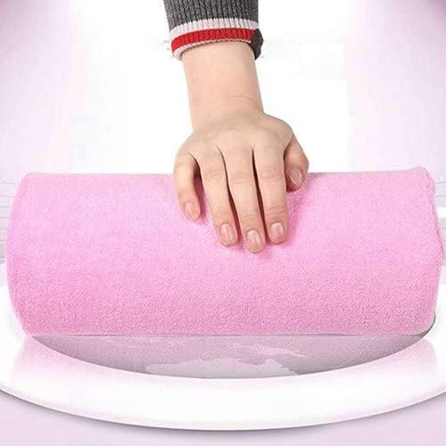 Nail technician using pink sponge hand cushion for steady manicure application