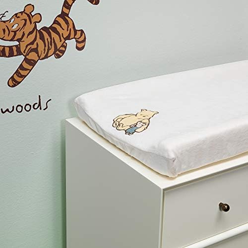 Side profile of the premium Disney baby changing pad cover highlighting the secure buttonholes for safety straps