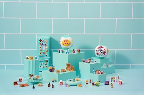 Miniature food replicas and decorative magnets arranged neatly on the toy refrigerator shelves