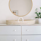Design Dua newborn wicker changing station showing interior pad liner