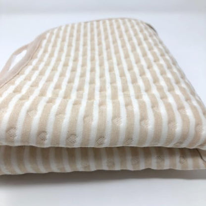 Tiny Undies striped baby changing pad used on a dresser