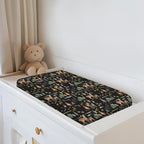 Baby changing pad cover styled on a standard nursery changing table