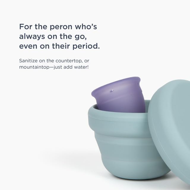 Sage green Saalt portable sanitizer next to a menstrual disc for size comparison.
