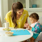 Close up view of the raised edge on the Munchkin silicone placemat containing a liquid spill.