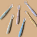 Full packaging view of the Little Rawr two count green silicone training spoons with portable carry box for travel.