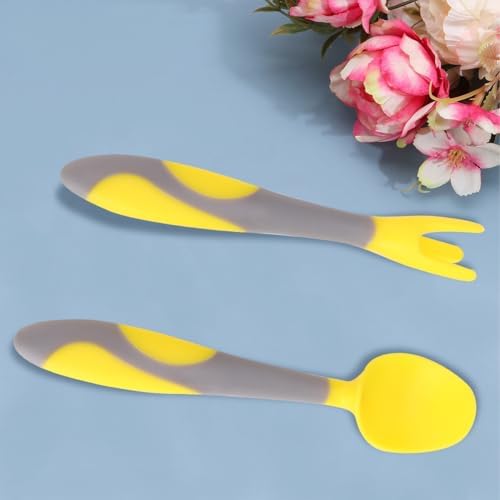 Close up of bendable handles on yellow learning utensils for babies