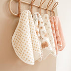 Konssy unisex infant burping cloths being used over the shoulder during baby feeding.