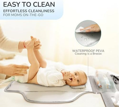 Grey portable baby changing pad attached to a stroller