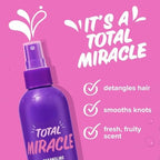 Aussie professional hair detangler mist being applied to long damp wavy hair