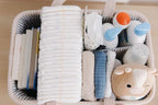 Side profile of baby pink diaper caddy with exterior pockets