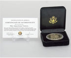 Twenty-four karat gold plated American Eagle Liberty tribute coin on desktop stand
