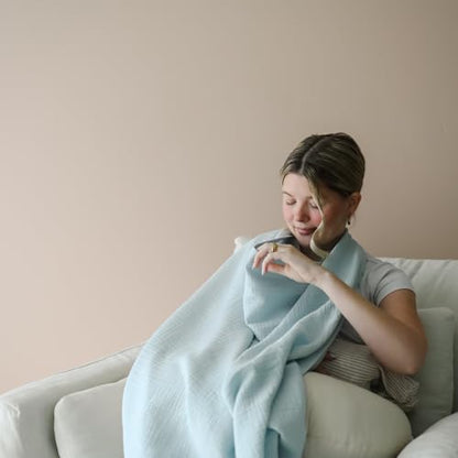 Snuggle Me nursing cover being used as a stroller sun shade