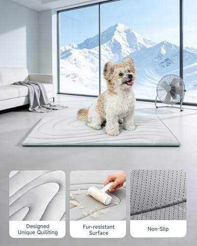 Grey washable dog cooling pad placed inside an indoor pet crate