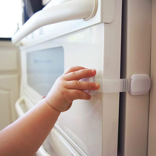 Adjustable baby proofing strap attached to a kitchen drawer