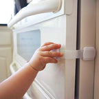 Adjustable baby proofing strap attached to a kitchen drawer