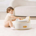 Side profile of Kindsgut dinosaur potty showing sturdy base handles