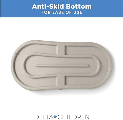 Baby changing pad with adjustable safety strap displayed on nursery furniture