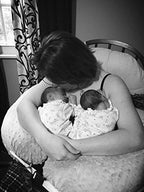 Parents using Twin Z pillow for feeding two babies comfortably