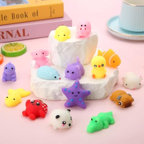 Assorted one to two inch mochi squishy fidget toys spread out on a clean surface