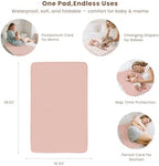 Konssy waterproof baby changing mat spread out on a bed showing its full coverage area.