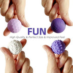 Close-up of a hand squeezing the PuraEase weighted magnetic balls to demonstrate tactile flexibility.