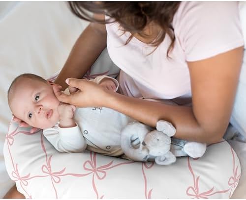 Close up of pink bow pattern on baby nursing pillowcase