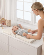 Premium flat foam baby changing station highlighting the secure safety buckle strap and cushioned mattress design