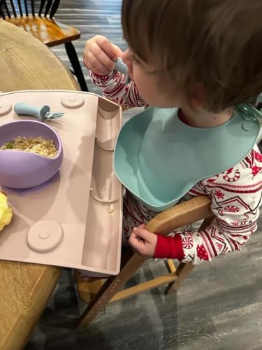 Child holding PandaEar ergonomic silicone handled cutlery