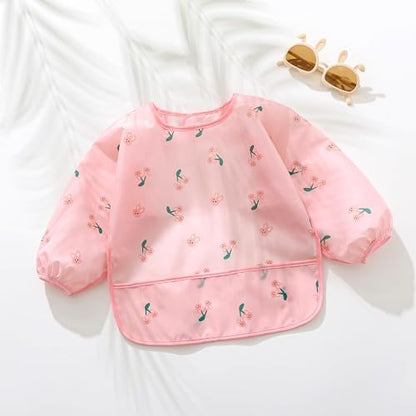 Hafftnun infant feeding smock folded compactly next to a packed diaper bag