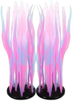 Fluorescent silicone fish tank decorations glowing vividly under blue aquarium lighting