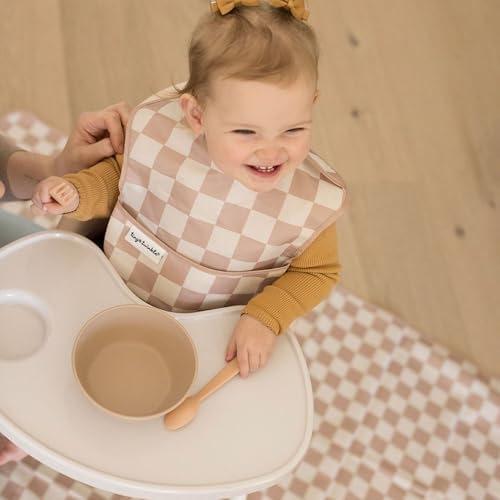 Tiny Twinkle mess proof mat being wiped clean with a cloth after a toddler mealtime spill
