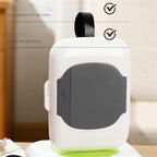 Gray travel wipe holder attached to a baby stroller