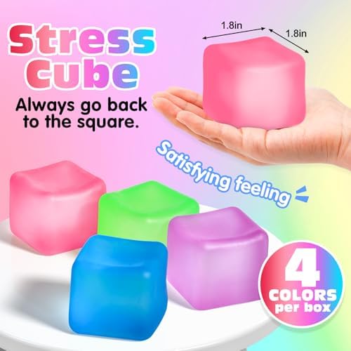 Four pieces of square shape nice cube fidget toys in blue green purple and pink resting on a flat surface.