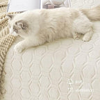 Tcksstex ivory pet mat being placed onto a large bedroom mattress.