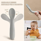 An infant holding the shortened handle of a blue NETANY silicone spoon demonstrating the ergonomic grip.