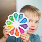 AFLUODN preschool learning tool being held by a toddler to practice finger coordination and fine motor skills.