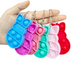 Close up view of the durable silicone bunny sensory push pop keychain attachments in multiple bright shades