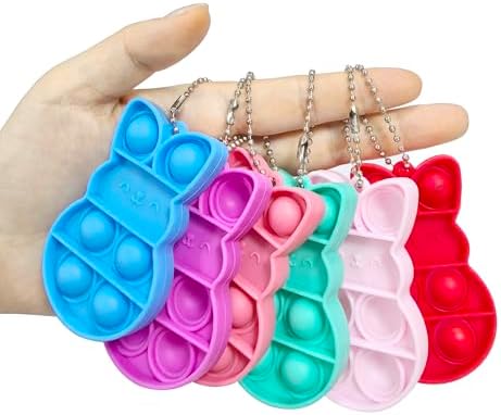 Close up view of the durable silicone bunny sensory push pop keychain attachments in multiple bright shades