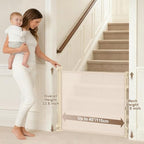 Spaceany retractable mesh dog gate installed at the bottom of a wooden staircase