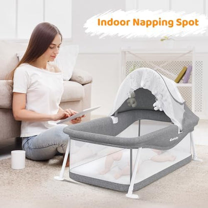 Ezebaby travel bassinet collapsed and folded flat next to its solid black carrying bag.