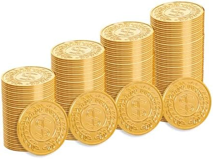 Plastic gold coins filling up a small black decorative Halloween cauldron