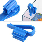 Aquarium filtration bucket mounting clip stabilizing a water change hose along a bucket edge.