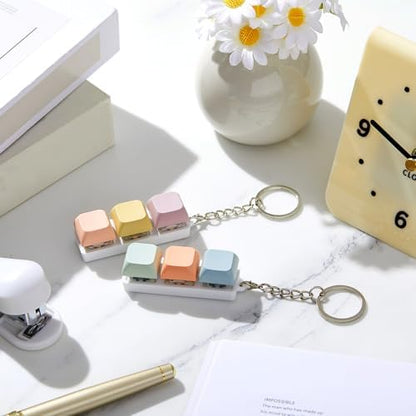 Taiyin portable finger clicker keychain attached securely to a backpack zipper pull